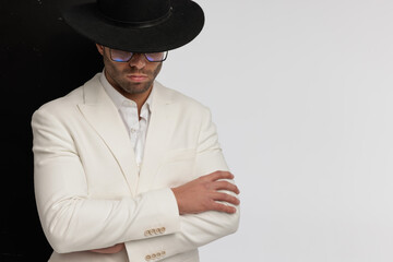 guy with a mysterious vibe crossing his arms