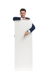 businessman presenting billboard and pointing down