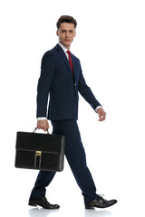 businessman walking and holding a briefcase to the side