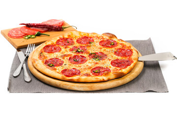 Picture of pepperoni pizza sitting on wooden countertop, next to the ingredients, photo is on white background. View from one side and top view. Italian pizza restaurant concept. Delicious pizza. 