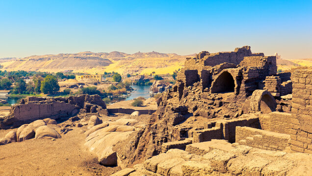 Ancient ruins of Upper Egypt and view of West bank of the Nile River. Aswan, Elephantine Island 
