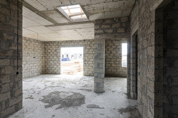 Construction of an individual residential building, view from the corridor to the large hall and doors to the rooms