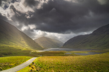 Road leading trough Doolough Valley with lakes, Glenummera and Glencullin mountain ranges...