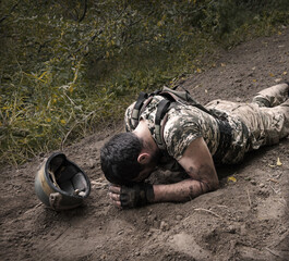 Sad soldier laying on the ground