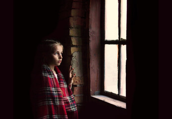 Girl at the window on a black background
