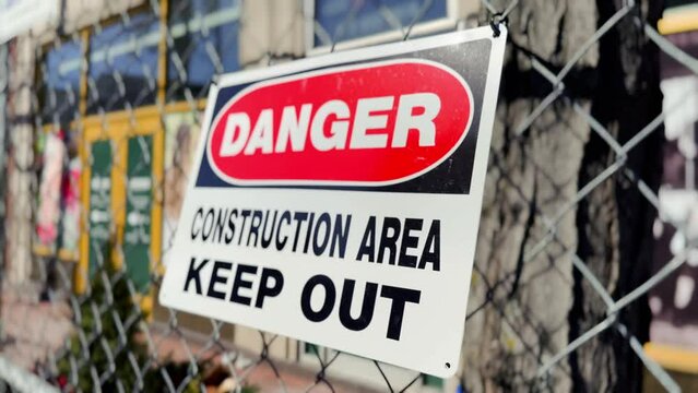 A close up view of a danger sign at a city construction site.  	