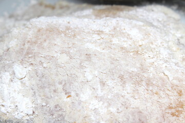 raw fish with flour to be fried. raw fish to be breaded. food texture. meal details. preparing the meal. fish meat to be used in the meal.