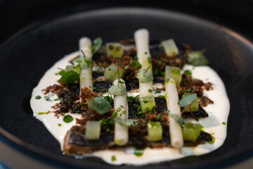 Restaurant food. Fish dish. Herring with horseradish, kohlrabi, cucumber and sunflower oil.