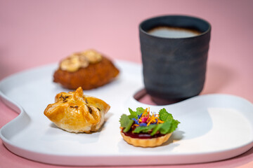 Restaurant food. Restaurant dish. Onion patty, goat cheese, potato donut, boletus broth. Trend colours.