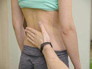 Physical Therapist checking patient backs in health center. medical examination for physical...
