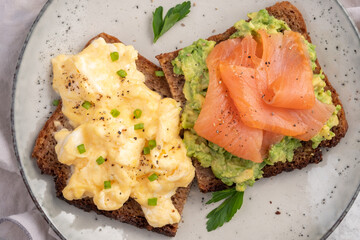 Scrambled eggs with smoked salmon and avocado on a whole wheat toast
