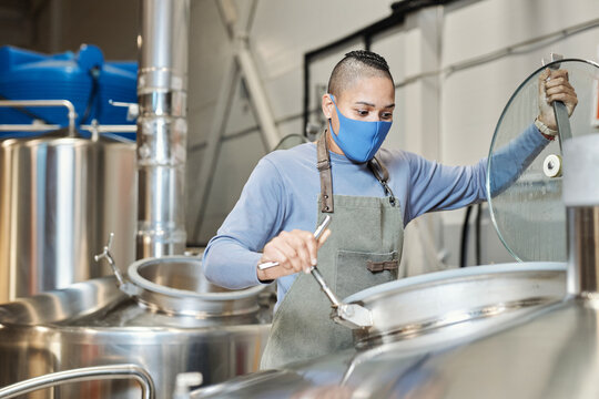 Female Worker Wearing Mask Opening Tanks At Beer Making Factory