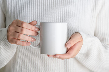 Female hands holding white mug mockup with blank copy space for your advertising text message or...