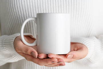 Female hands holding white mug mockup with blank copy space for your advertising text message or...