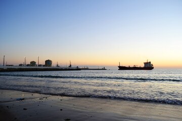 Fototapeta premium Merchant ship near a seaport in a natural setting