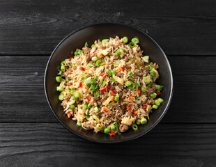 Asian Beef Fried Rice with eggs and vegetables in black bowl