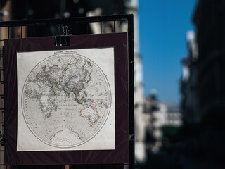 Old vintage world map at a street vendor in a city