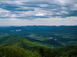 Naklejka premium Aerial view of a white fortress castle with forest and hills