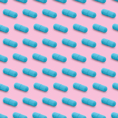 Gel capsule seamless pattern. Blue capsule shaped medicine. pharmacy concept. food supplement. Capsule pills pattern on a pink background