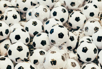 Pattern photo of some bunch of black and white football or soccer mini balls.