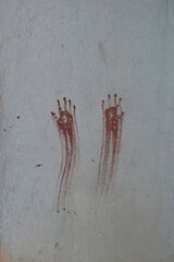 Two bloody hands asking for help symbol painted with red on a wall - 573356954