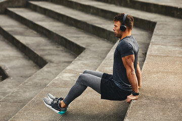 Young fit man workout outdoors on concrete steps