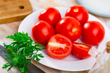 Ripe red tomatoes on wooden background, food preparation