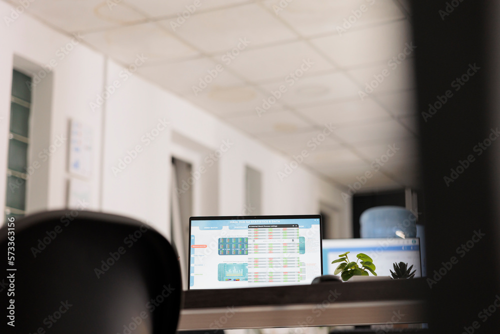 Poster portrait of portable computer with screen on with financial software placed on modern work table wit