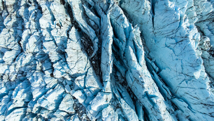Huge glacier with pure blue ice at sunny weather. Vatnajokull glacier in Iceland. Beautiful nature abstract background. Ice texture landscape aerial view.
