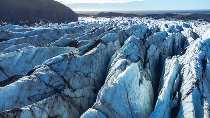 Huge glacier with pure blue ice at sunny weather. Vatnajokull glacier in Iceland. Beautiful nature abstract background. Ice texture landscape aerial view.