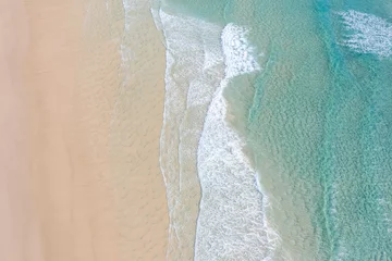 Aerial view of a beach with idyllic tropical blue water and gentle waves  © FRPhotos