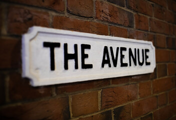 Fototapeta premium Street name called The Avenue on a red brick wall
