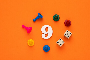 Number 9 with dice and board game pieces - Orange eva rubber background