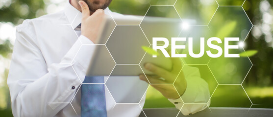 The concept of circular economy and reuse for future growth of business and clean environment. Businessman holding digital device in hands and solving problems of reusing products.