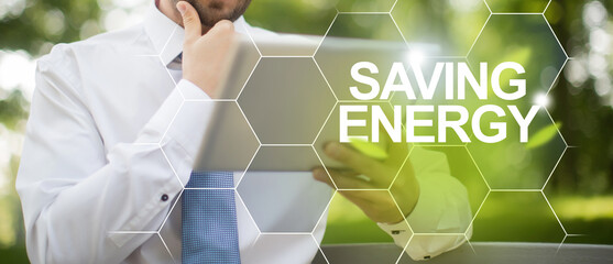 Ecosystem safe environment and energy saving. Businessman holding digital device in hands and...