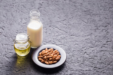Oil, milk and almond seeds (Prunus dulcis) close-up image