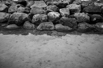 Boulders with Water Below in Black and White.