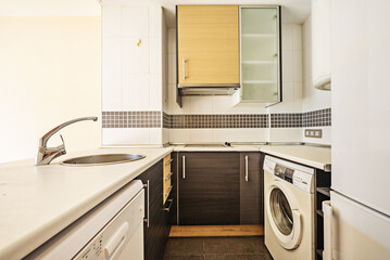 kitchen with serving hatch, two-tone wooden furniture, white walls, white appliances, border and...