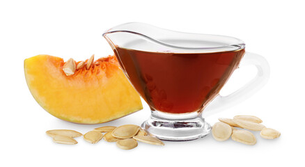 Fresh pumpkin seed oil in glass sauceboat isolated on white