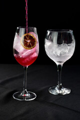 alcoholic iced drink of gin and tonic vodka soda citrus fruit juice lemonade with cinnamon isolated on black background