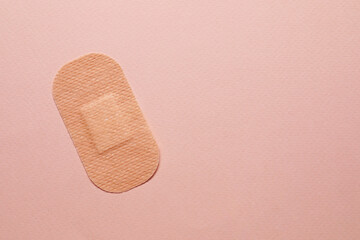 Contraceptive patch on pink background, top view. Space for text