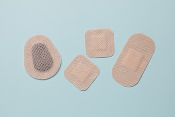 Contraceptive patches on light blue background, flat lay