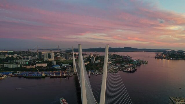 Aerial sunset views of Vladivostok city with famous cable-stayed bridge over Golden Horn bay