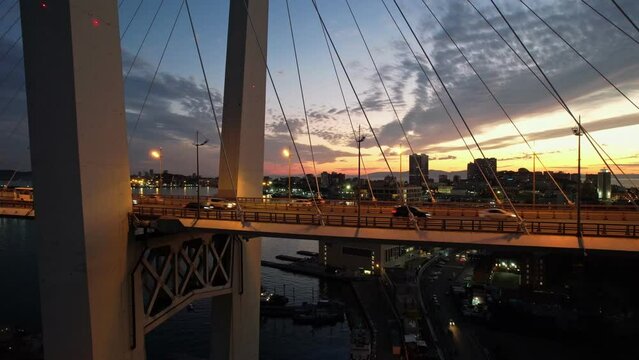 Aerial sunset views of Vladivostok city with famous cable-stayed bridge over Golden Horn bay