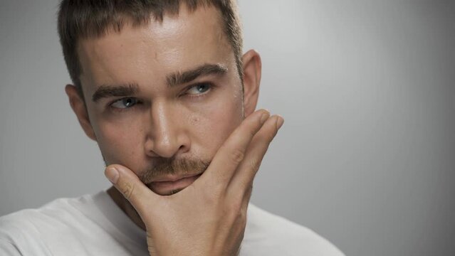 Handsome bearded man with clean skin against gray background