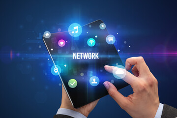 Businessman holding a foldable smartphone