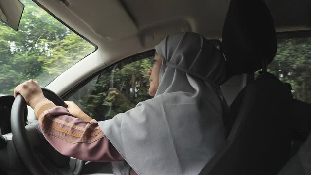 Female Asian muslim driver sleeping while driving a car, dangerous traffic safety accident crash car insurance long trip tired