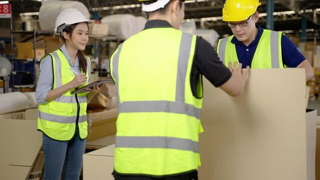 Warehouse workers are helping to pack boxes.
