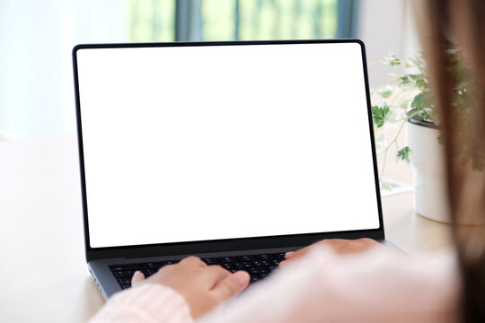 Woman using laptop computer with blank screen for mock up template background, people business technology and lifestyle background concept