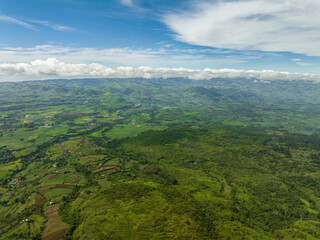 Aerial view of valley with farmland and agricultural land in mountainous area. Negros, Philippines